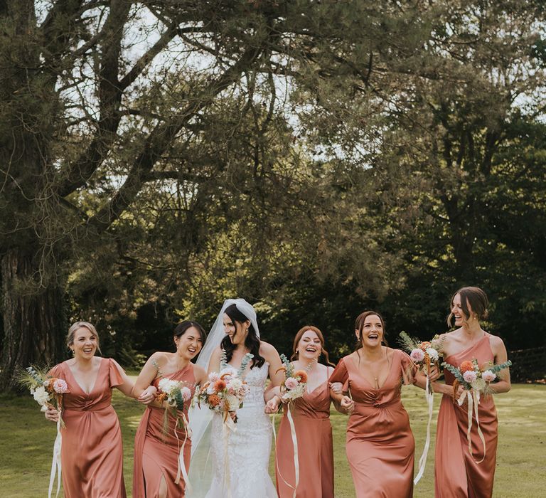 peach-bridesmaid-dresses-with-bride-in-lace-wedding-dress