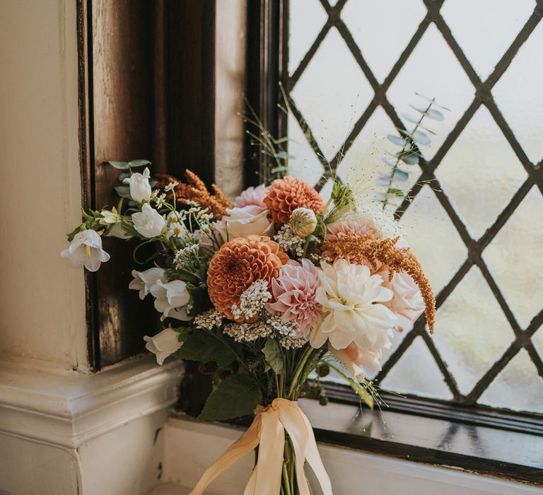 peach-coral-and-pink-wedding-bouquet-tied-with-ribbon