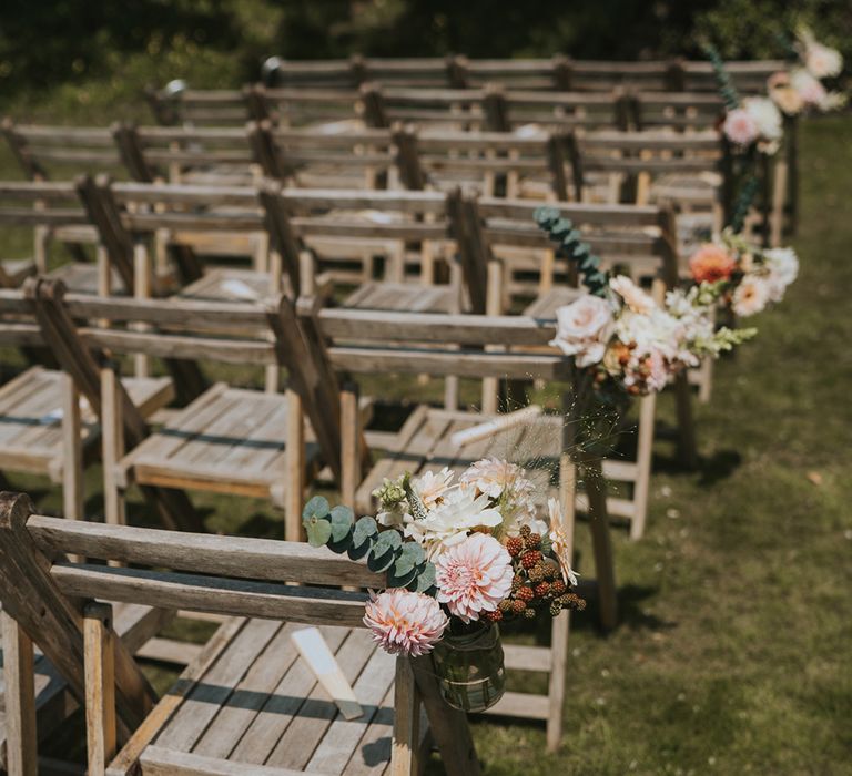 small-pots-attached-to-wedding-chairs-for-outdoor-wedding