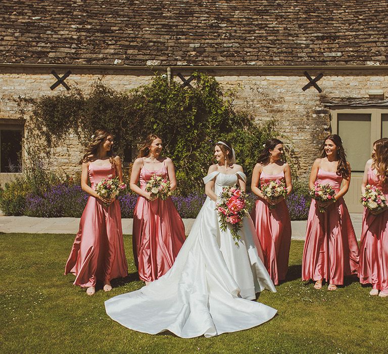 bridal-party-wearing-pink-satin-bridesmaid-dresses