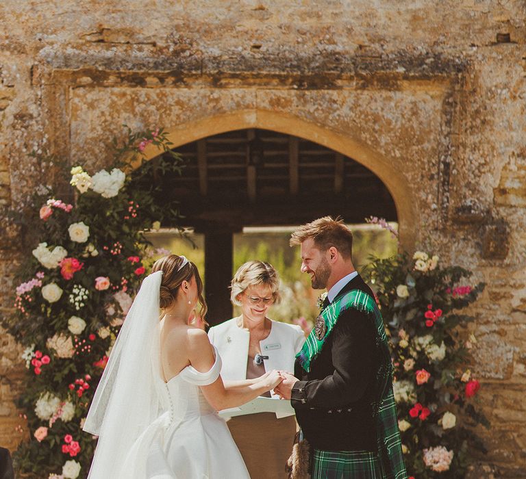 bride-and-groom-exchnage-wedding-vows-at-caswell-house