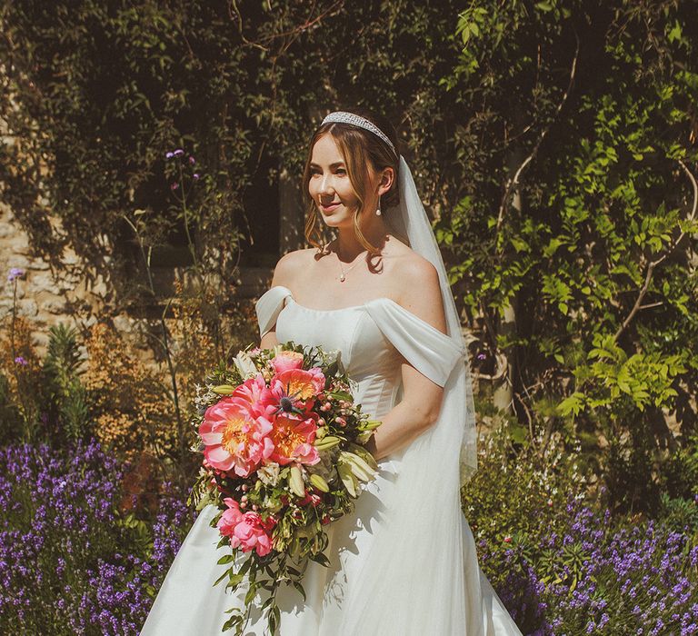 bride-in-off-the-shoulder-corset-wedding-dress-with-pink-cascading-wedding-bouquet