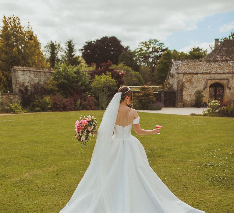 bride-wearing-princess-wedding-dress-with-off-the-shoulder-and-veil