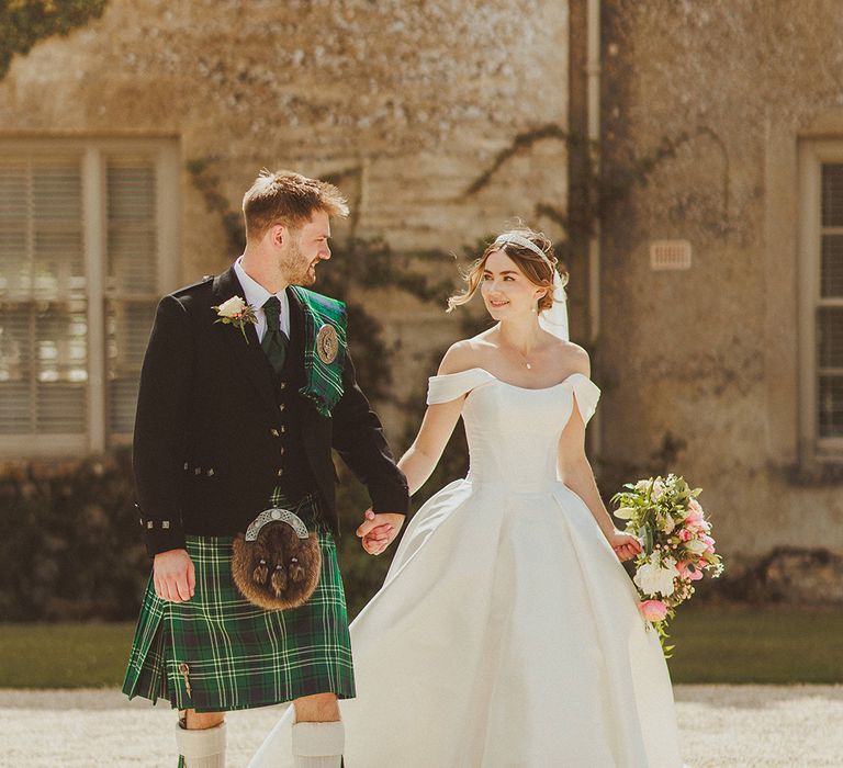 groom-in-scottish-kilt-wedding-suit-with-bride-in-princess-wedding-dress