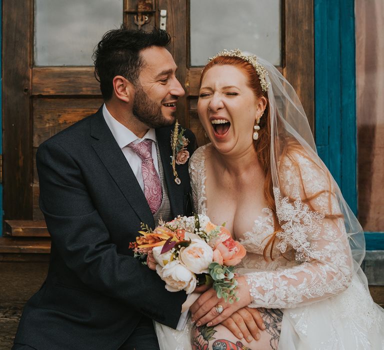 bride-and-room-laughing-together-at-rustic-wedding