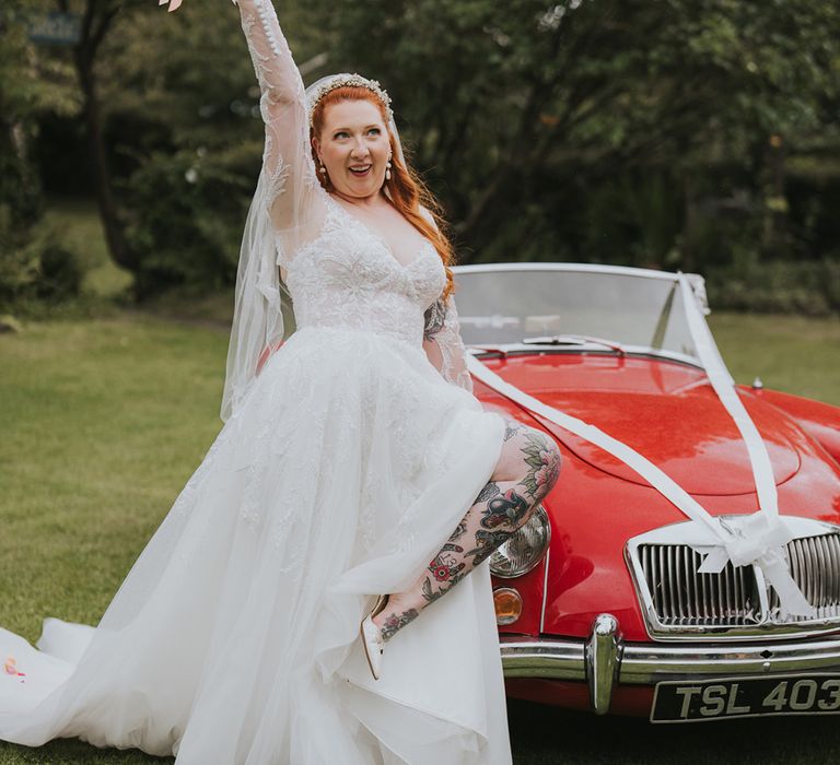 bride-in-long-sleeve-lace-wedding-dress-with-red-wedding-car