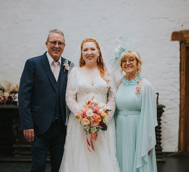 bride-with-mother-and-father-fo-the-bride-in-blue-wedding-outfits