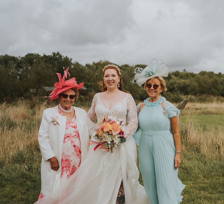 bride-with-wedding-guests-in-pink-and-blue-outfits