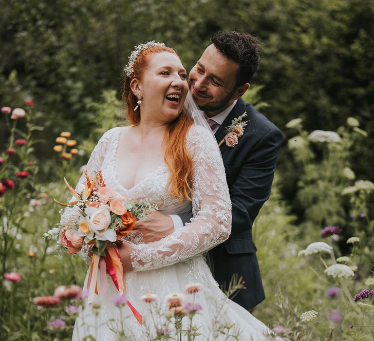 groom-embraces-bride-from-behind