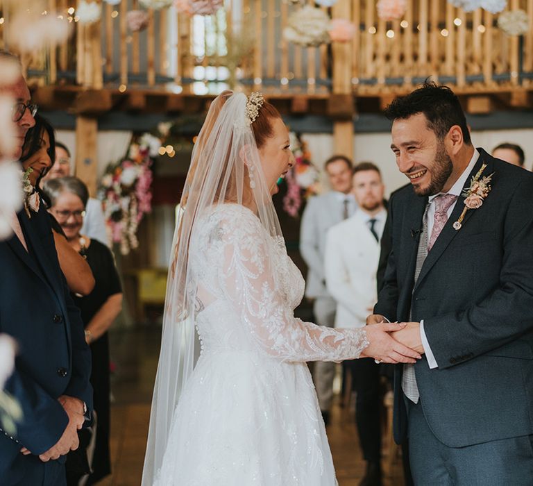 groom-holding-hands-with-bride-at-wedding-ceremony