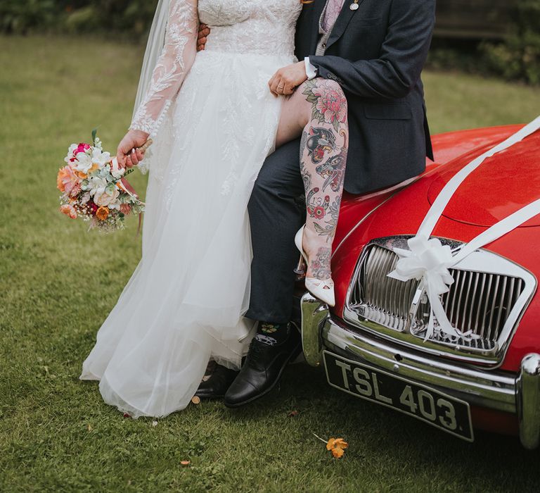 tattooed-bride-posing-with-groom-for-couple-portrait