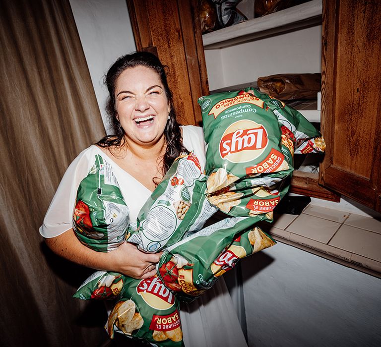 bride-smiles-with-bags-of-lays-crisps