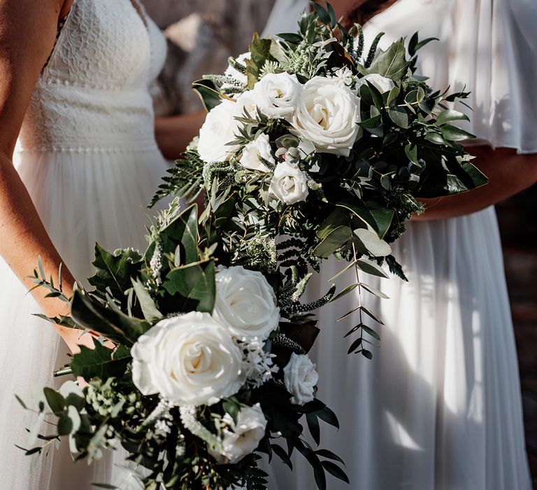 brides-holding-white-flower-wedding-bouquets