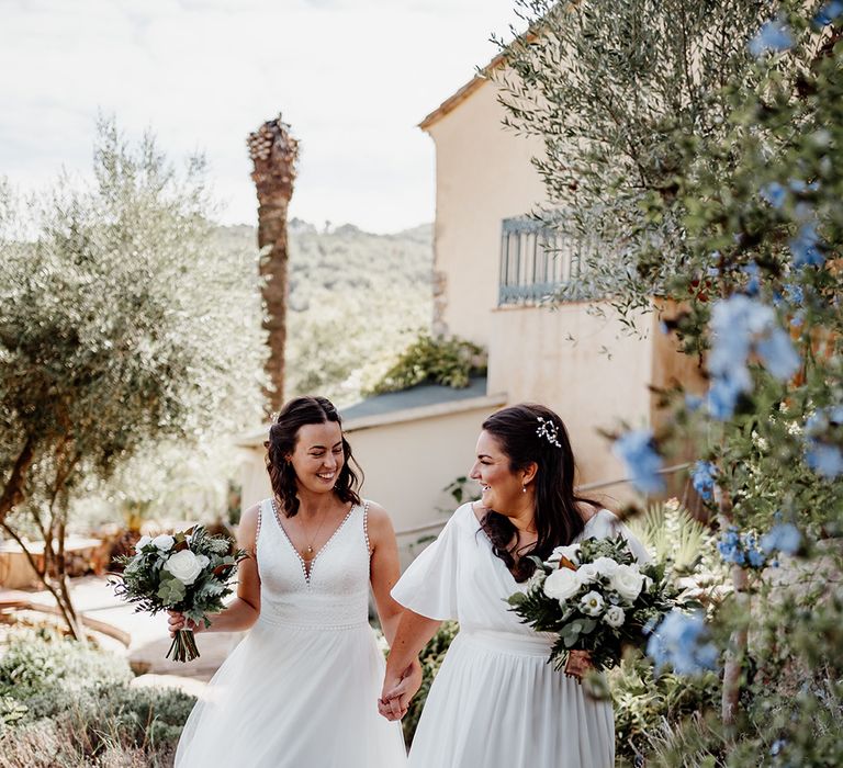 brides-walking-hand-in-hand-for-wedding-photos