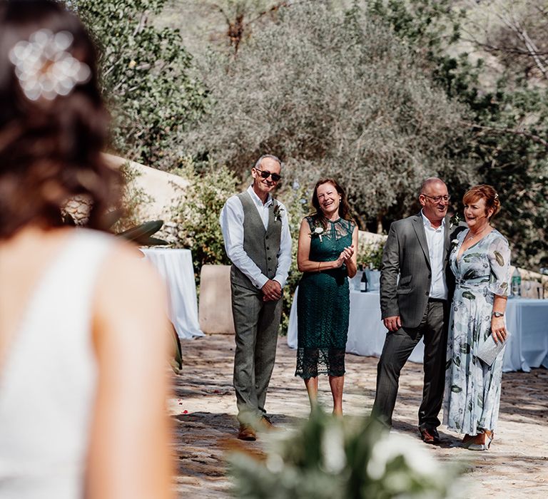 parents-of-the-brides-smiling-for-first-look-moment