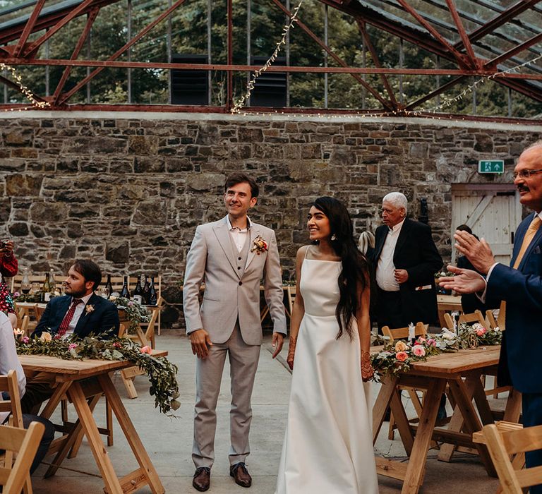 bride-and-groom-entrance-to-their-wedidng-breakfast