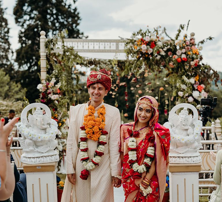 bride-and-groom-walking-back-down-the-aisle-as-married-couple-for-wales-wedding