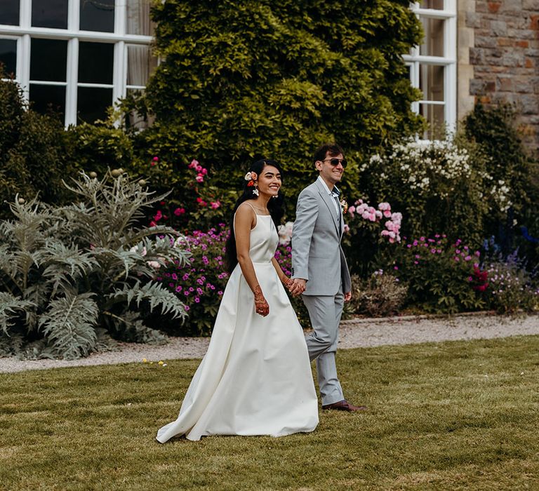 country-house-wedding-in-wales-with-the-bride-and-groom-exploring-the-wedding-venue