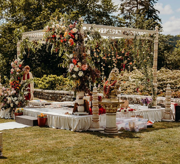 mandap-outdoor-wedding-ceremony-with-red-and-orange-flowers