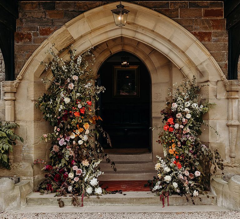 orange-and-red-wedding-flower-column-decorations-at-church-entrance