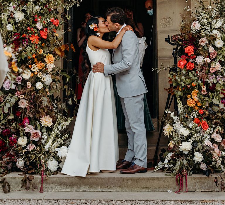 red-and-orange-wedding-flower-column-entrance-decor