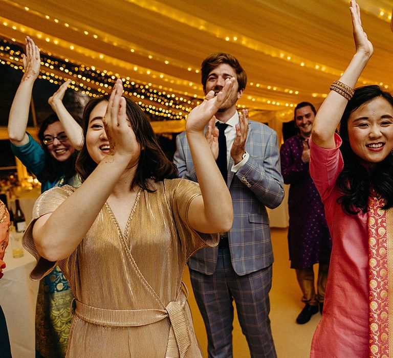 wedding-guests-clapping-and-dancing-at-wedding-reception