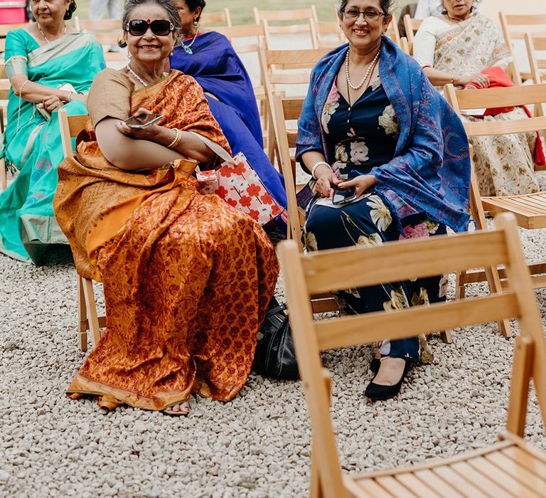 wedding-guests-in-traditional-cultural-wedding-outfits-for-outdoor-wedding