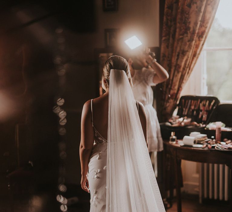 bride-wearing-lace-wedding-dress-with-cathedral-length-wedding-veil