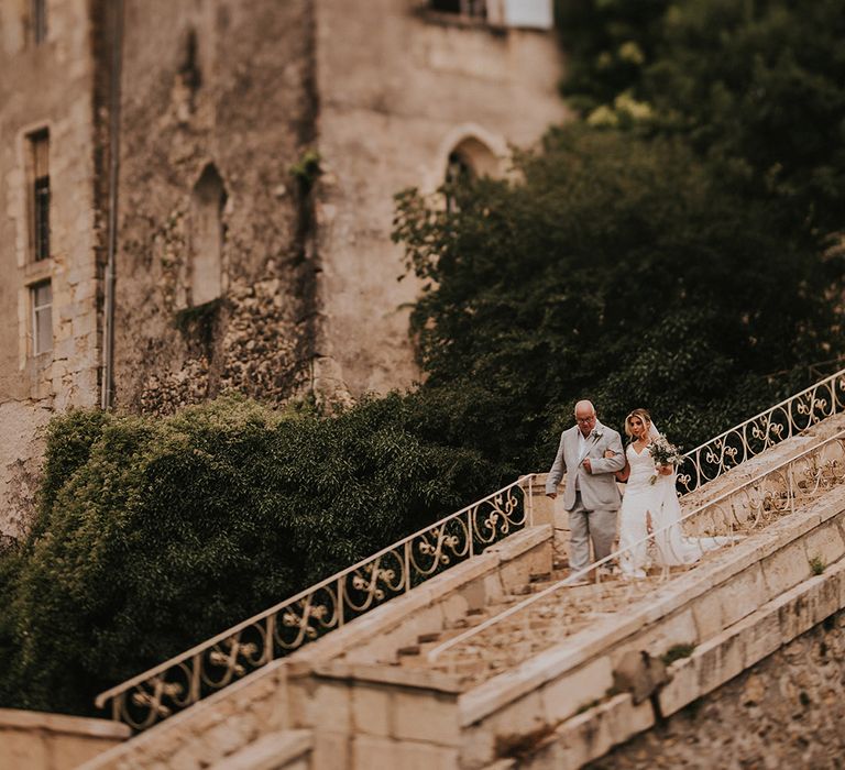 father-of-the-bride-walking-down-the-stairs-with-bride-at-destination-wedding