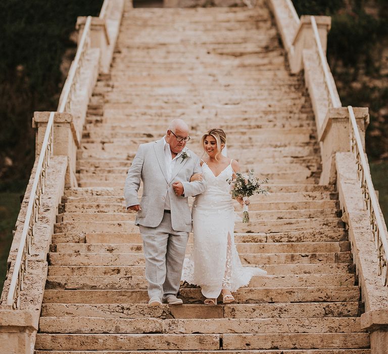 father-of-the-bride-walking-with-bride-to-the-destination-wedding