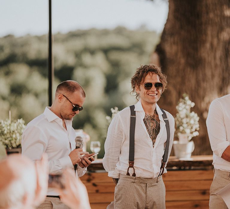 groomsmen-in-white-shirts-standing-for-speeches