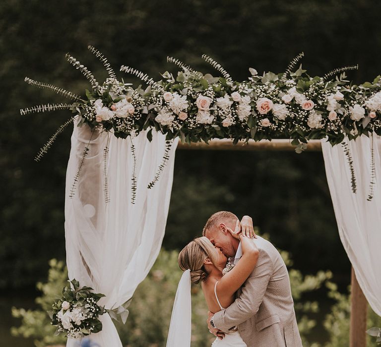 outdoor-wedding-with-neutral-pink-flowers-with-drapery