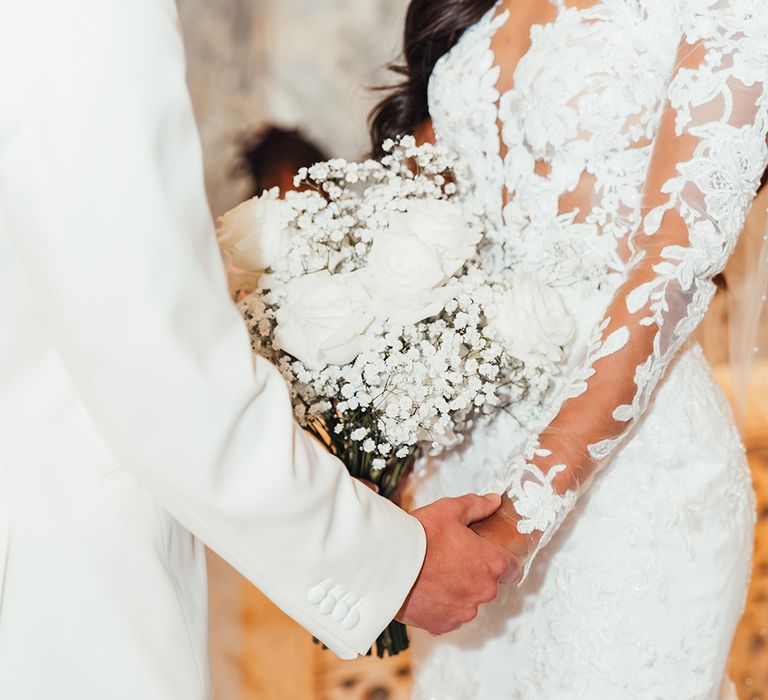 bride-holding-bouquet-of-roses-and-gypsophila