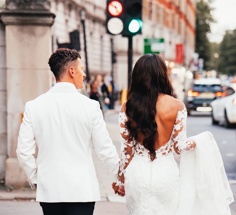 bride-with-long-hair-wearing-low-back-wedding-dress-with-groom-in-tuxedo