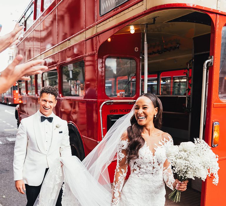 groom-carries-brides-train-for-london-wedding