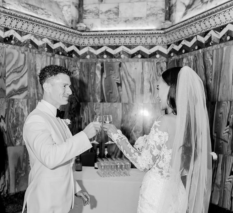 groom-cheers-toast-with-bride-after-ceremony