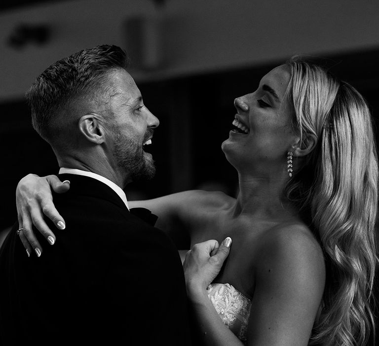 bride-and-groom-smiling-during-first-dance