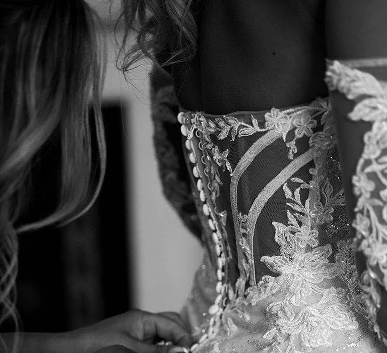 bride-gets-buttoned-into-lace-wedding-dress