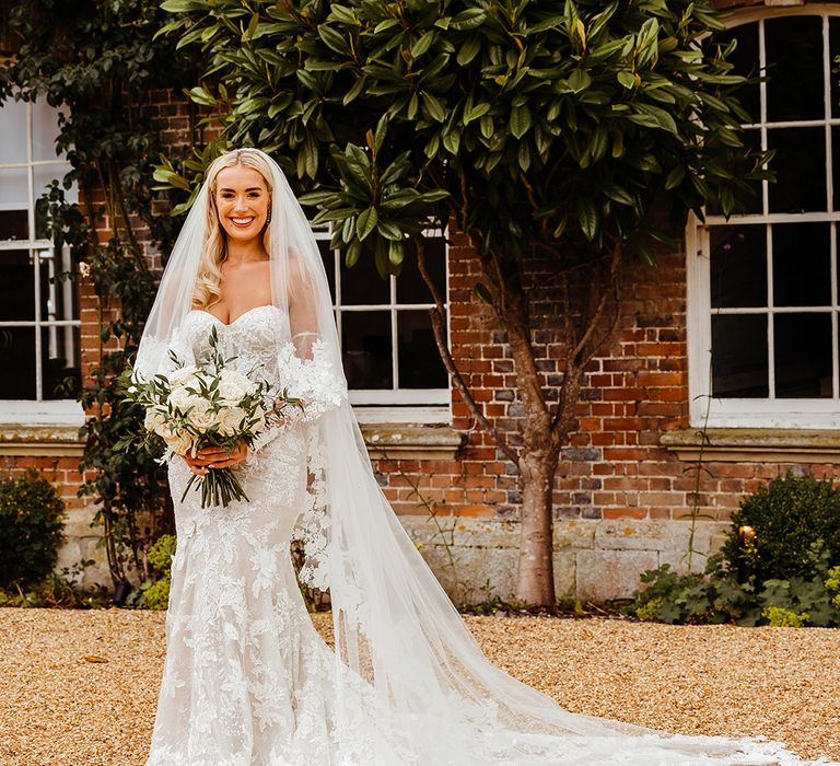 bride-in-long-sleeve-lace-wedding-dress-with-floral-embroidered-wedding-veil