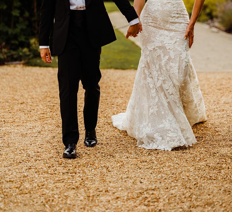 bride-in-strapless-lace-wedding-dress-with-groom-in-black-tuxedo