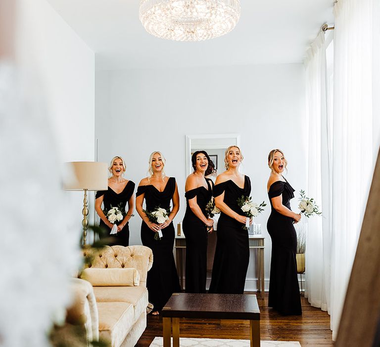 bridesmaids-get-first-look-at-bride-in-black-bridesmaid-dresses