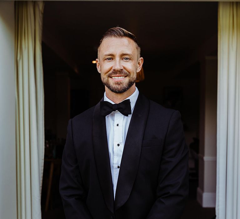 groom-in-black-tuxedo-for-wedding-day