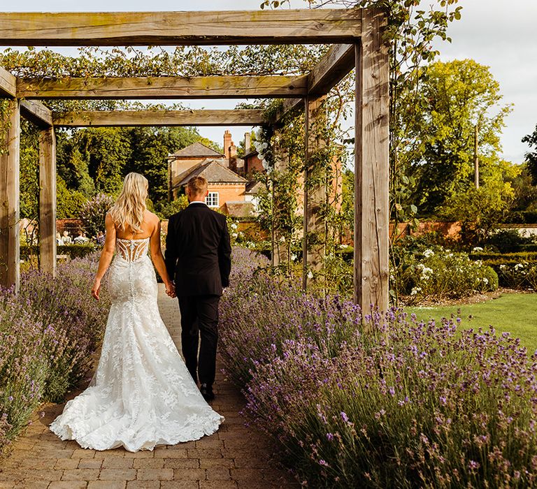 mesh-back-corset-detail-wedding-dress-with-groom-in-black-tuxedo