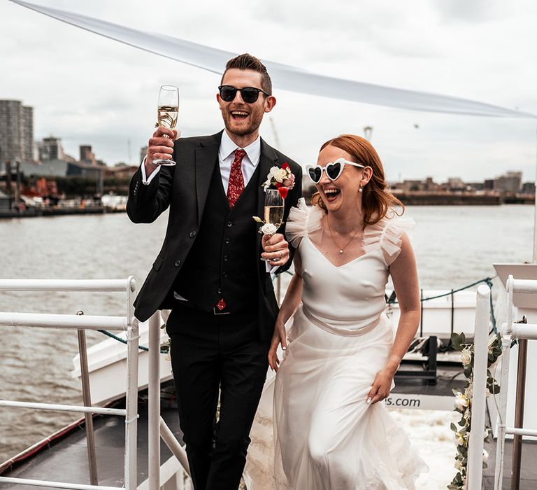 bride-and-groom-make-their-entrance-on-boat-for-drinks-reception