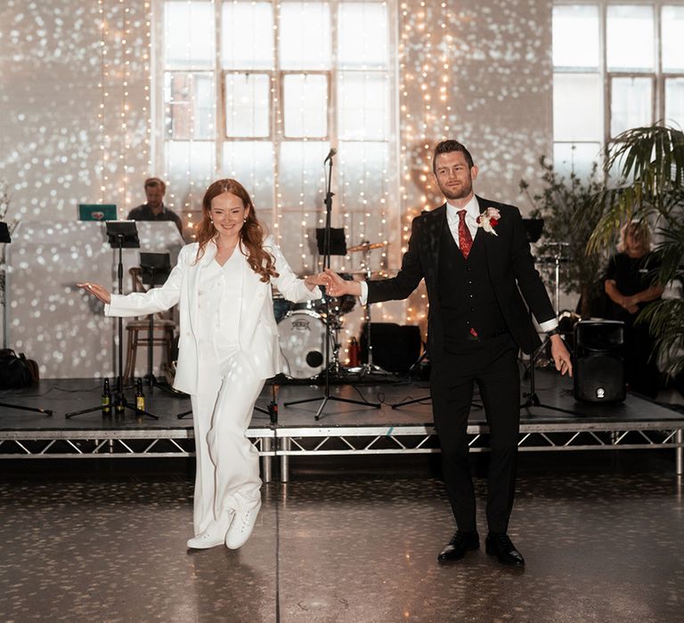 bride-in-white-bridal-suit-dancing-with-groom-fo-first-dance