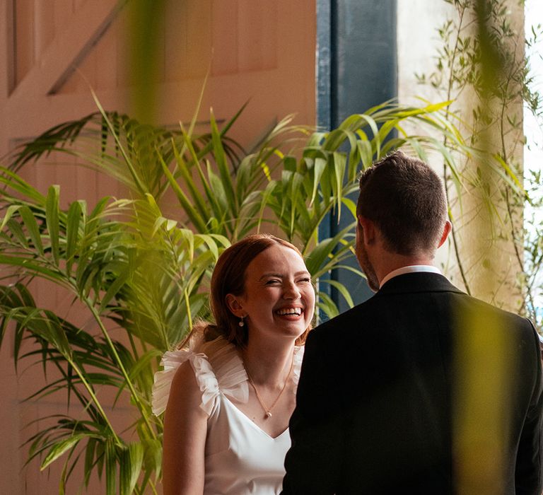 bride-smiling-at-groom-at-wedding-ceremony