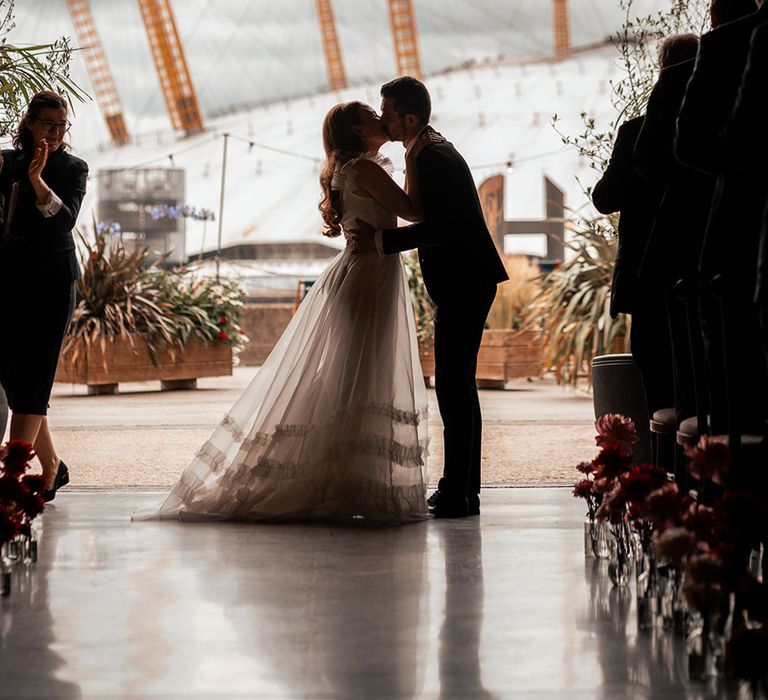 first-kiss-for-bride-and-groom-at-wedding-ceremony