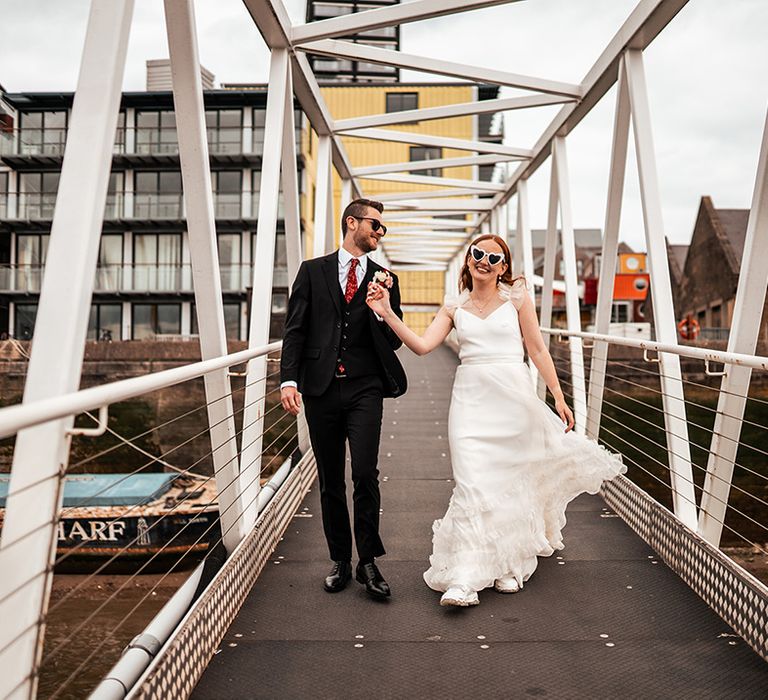 groom-walks-with-bride-to-the-boat-for-drinks-reception