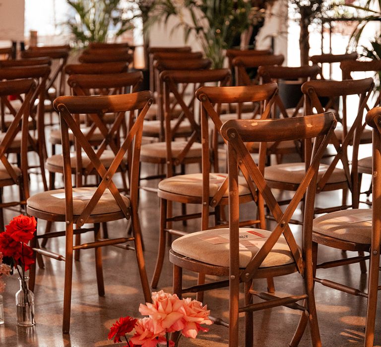 pink-and-red-flowers-aisle-decorations-with-wooden-chairs