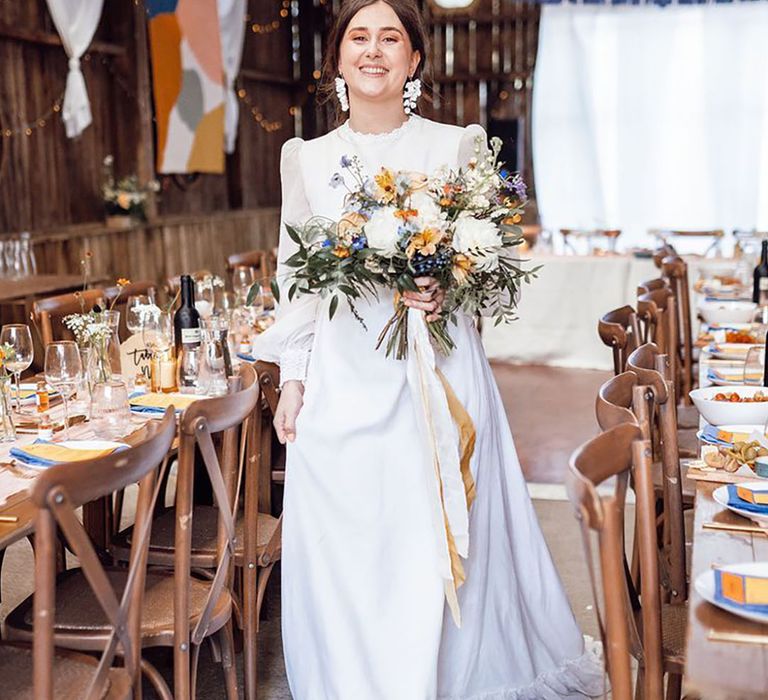 bride wearing long sleeve, high neck vintage style wedding dress